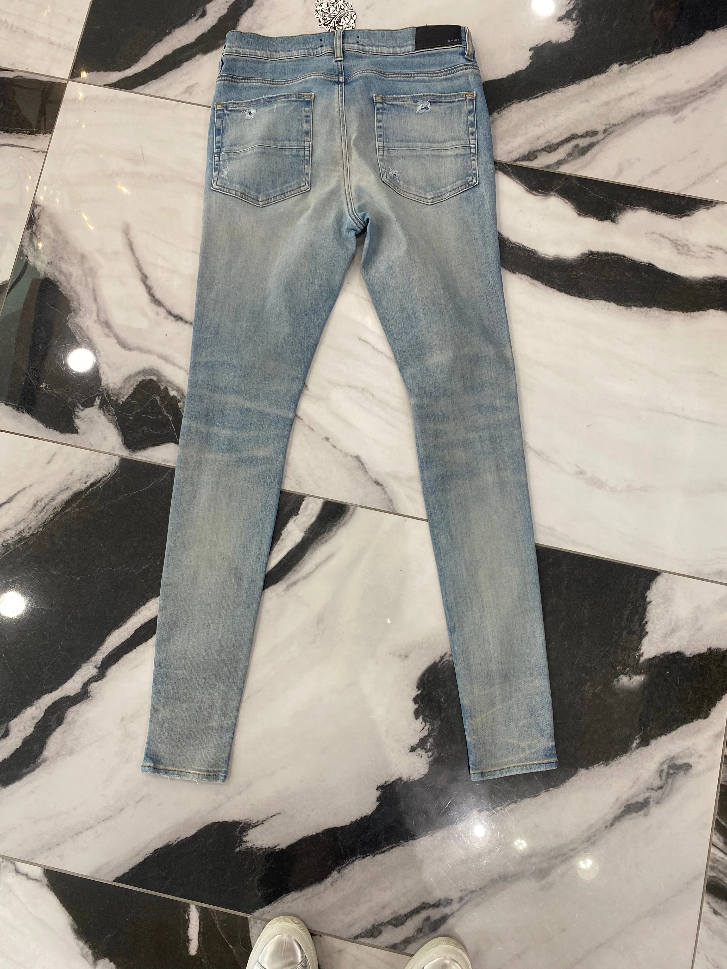 AMIRI DISTRESSED SKINNY JEANS